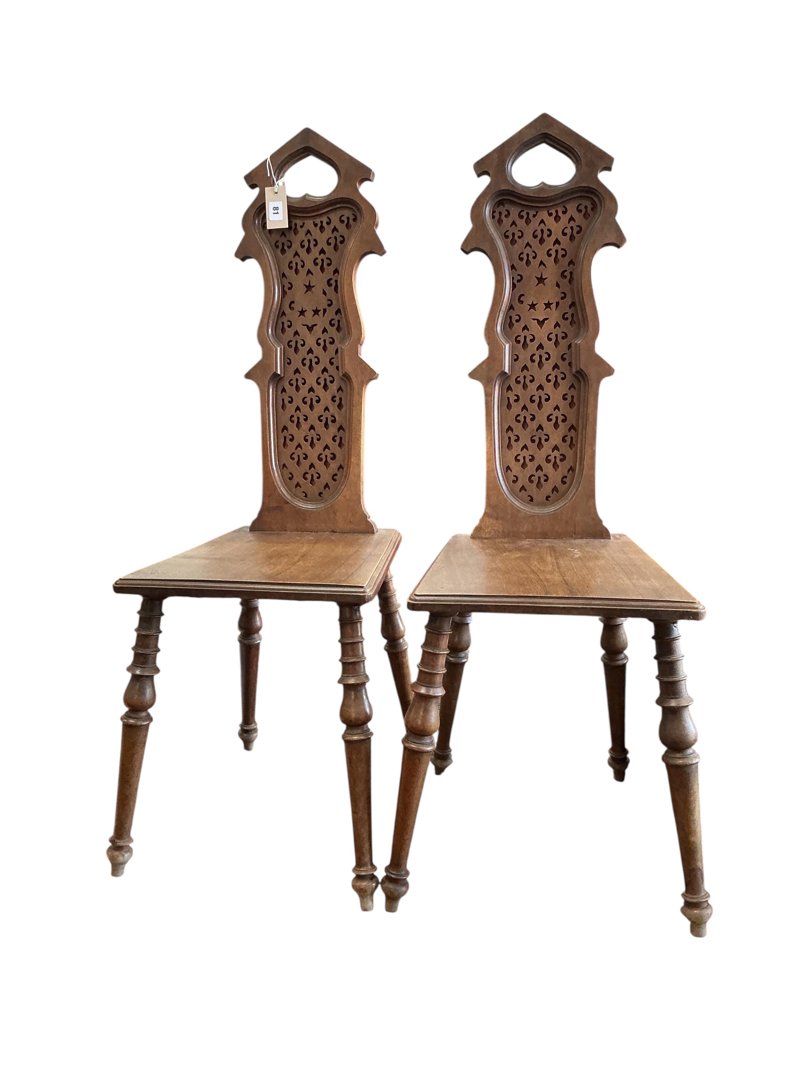 A pair of early 20th century French carved walnut hall chairs, width 36cm, depth 40cm, height 108cm